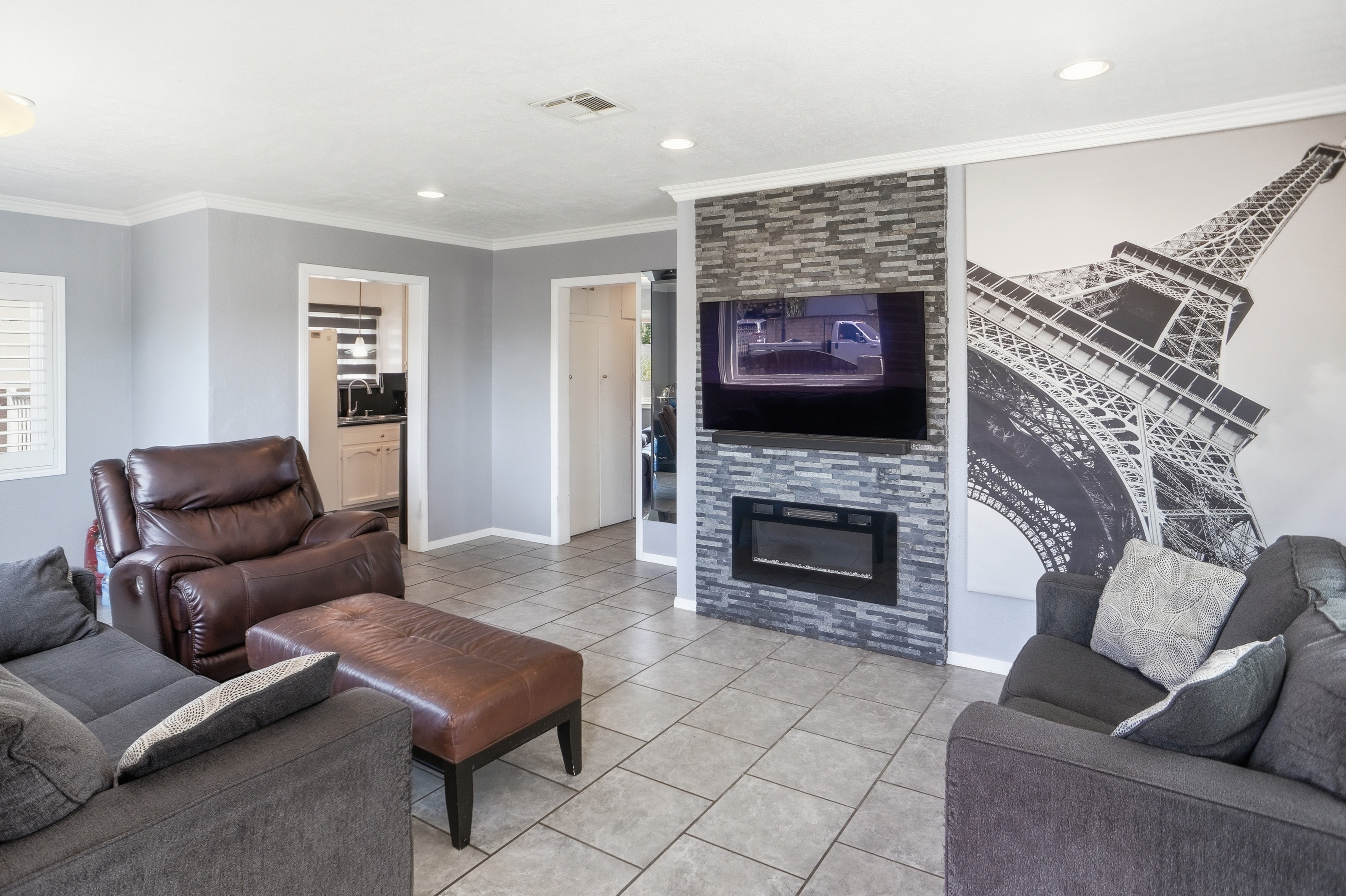 Living room with stone accent wall and electric fireplace